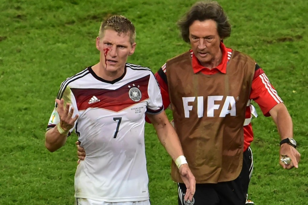 Germany midfielder Bastian Schweinsteiger walks off the pitch, bloodied after a collision during extra time in the final against Argentina. He is favourite to become Germany captain. Photo: AFP