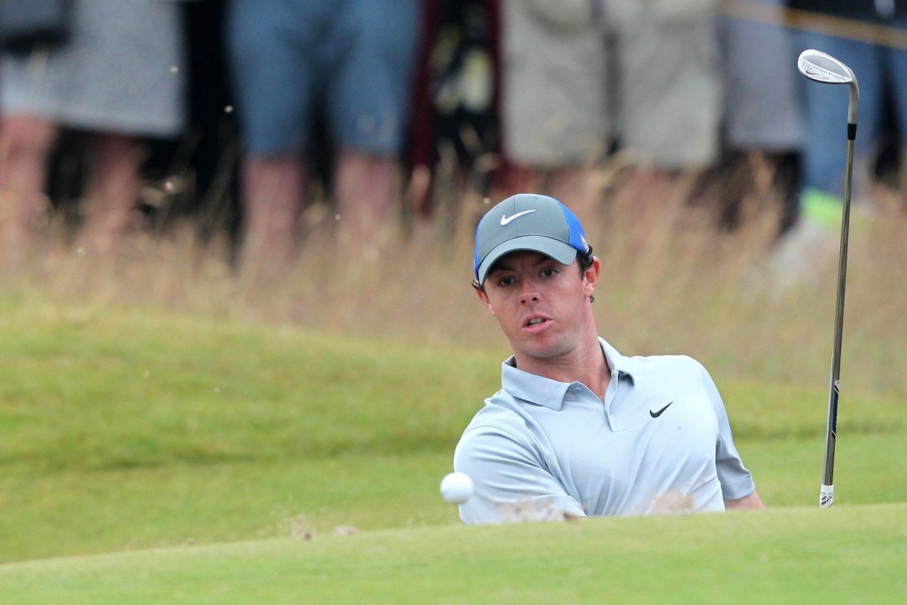 Northern Ireland's Rory McIlroy plays out of a green-side bunker on the first hole on the third day of the British Open, taking a six-shot lead into the final round. Photo: AFP