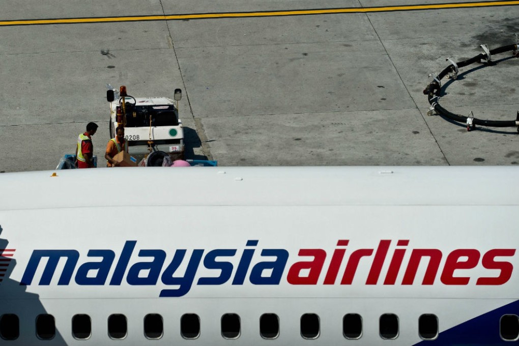 Groundstaff prepare a Malaysia Airlines plane for departure at Kuala Lumpur International Airport on Sunday. Photo: AFP