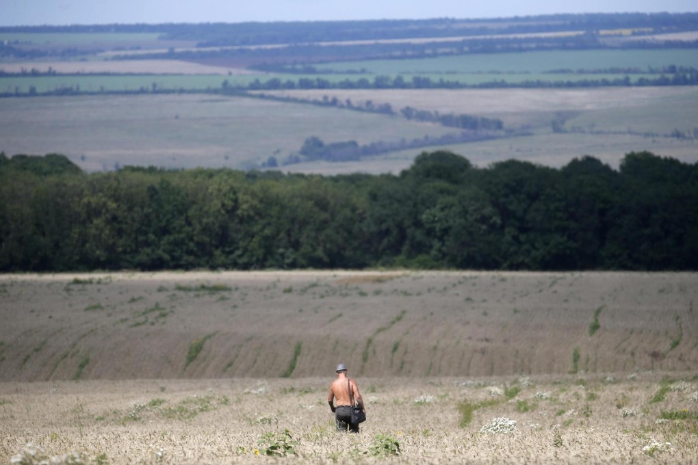 A Ukrainian coal miner takes part in a search of the sprawling site where Malaysia Airlines flight MH17 came down. Photo: Reuters