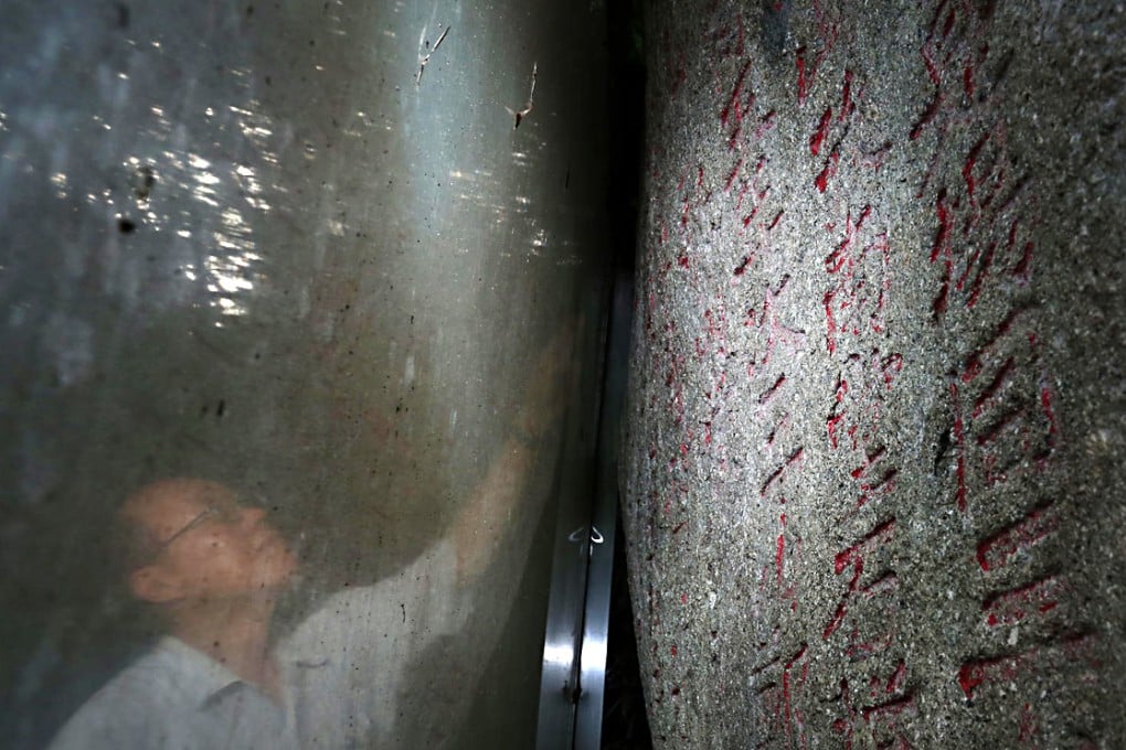 Ho Koon-wan, of Polytechnic University's Chinese culture department, admires the centuries-old inscription. Photo: Nora Tam