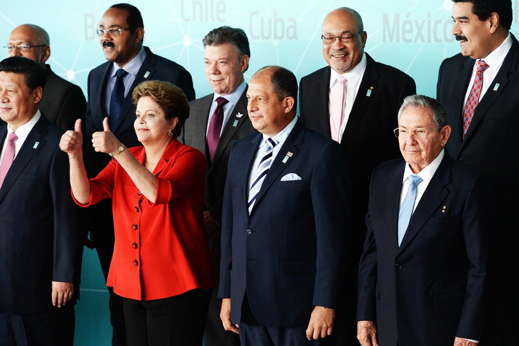 (Front row from left) China's President Xi Jinping, Brazilian President Dilma Rousseff, Costa Rica's President Luis Guillermo SolÌs and Cuba's President Raul Castro, (Back row from left) Antigua and Barbudaís Prime Minister Gaston Browne, Colombia's Presidente Juan Manuel Santos, Suriname's President Desire Bouterse and Venezuela's President Nicolas Maduro pose for the family photo of the China-Celac forum at Planalto Palace in Brasilia. Photo: AFP