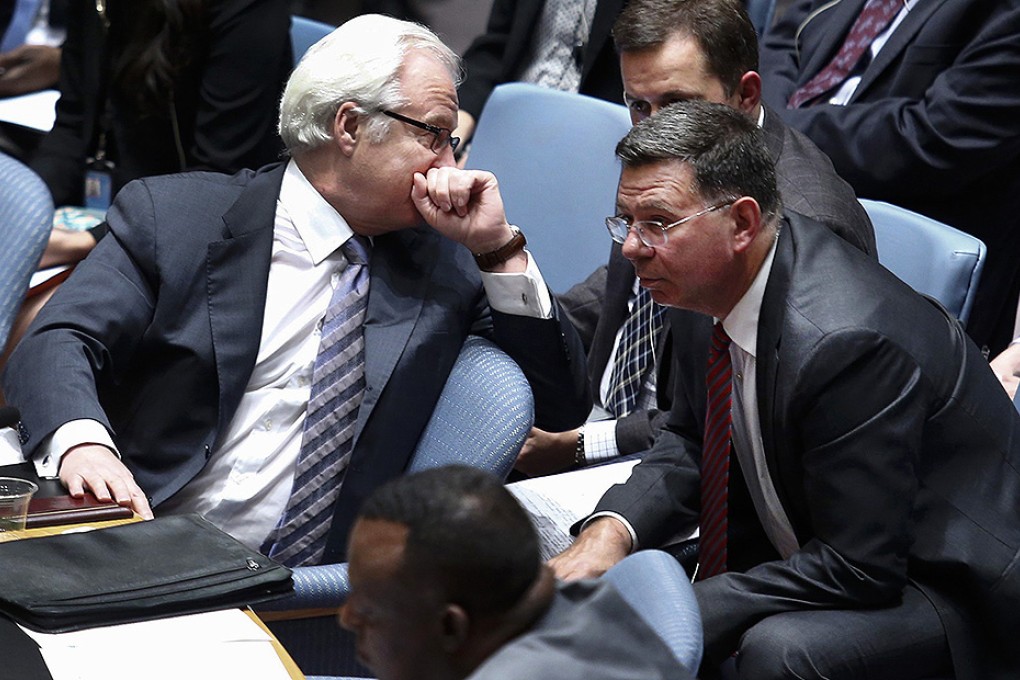Russia's Ambassador to the United Nations Vitaly Churkin (left) speaks with his delegates during a meeting at United Nations headquarters in New York. Photo: Reuters