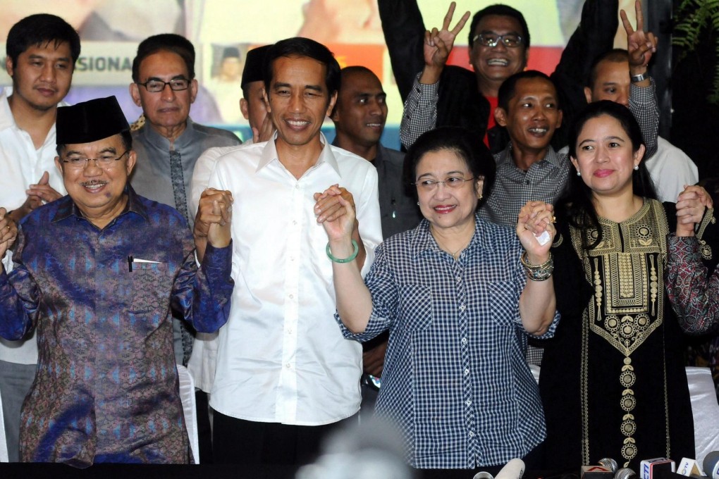 Indonesia's president-elect Joko Widodo is flanked by running mate Yusuf Kalla, former president Megawati Sukarnoputri and (right) Puan Maharani, Megawati's politically ambitious daughter. Photo: EPA
