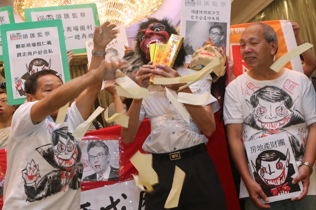 Demonstrators send a clear message at The Mira Hong Kong in Tsim Sha Tsui during The Link Reit's AGM yesterday. Photo: David Wong