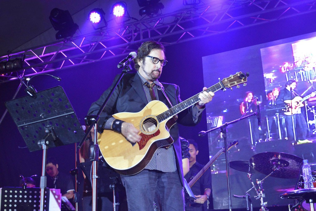 Guitar man: Bishop (above and below) penned songs for Barbra Streisand and Johnny Mathis, but still enjoys performing himself.