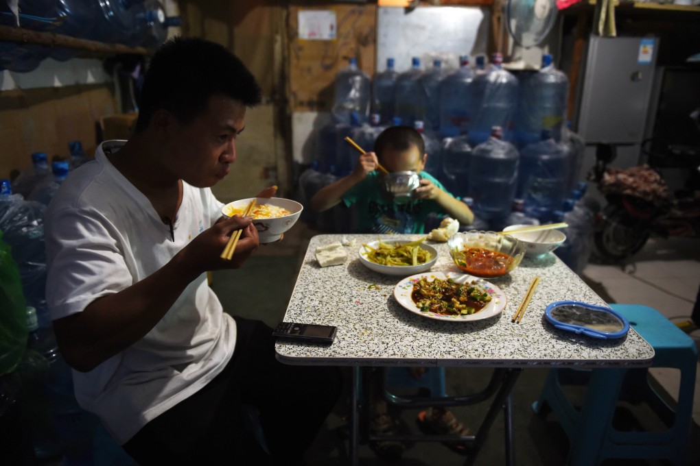 The family of a small business owner in Beijing having dinner. The central government wants local officials to pay more attention to people's livelihood concerns. Photo: AFP