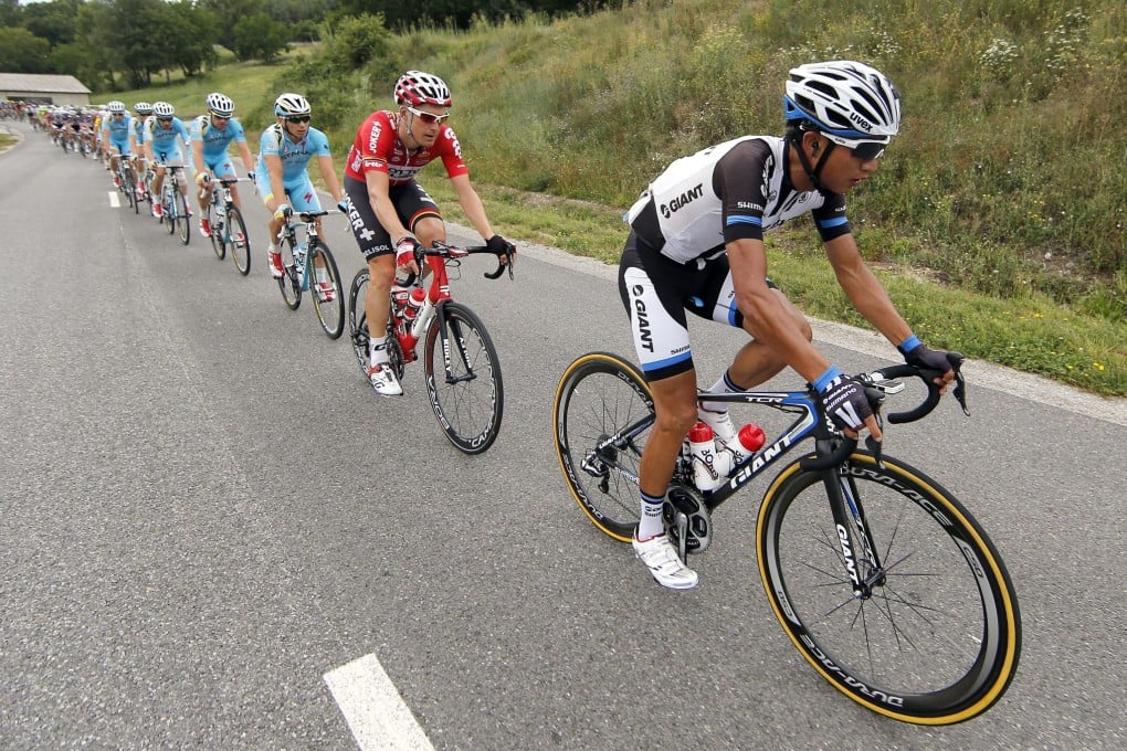 Giant-Shimano team rider Ji Cheng of China leads the pack during the 15th stage of the Tour de France. Although he is last in the overall standings, Ji has won praise for doing the donkey work for his team, especially in sprint stages. Photo: EPA