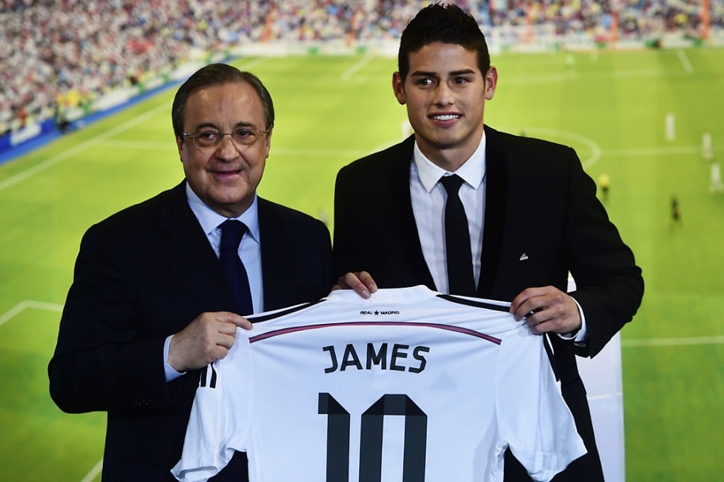 Real Madrid president Florentino Perez presents Colombian striker James Rodriguez with a club shirt during his presentation at the Santiago Bernabeu stadium following his signing with the Spanish club. Photo: AFP