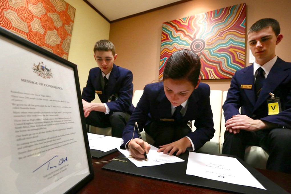 Australian Air Force cadets sign the book of condolence this morning in Wan Chai. Photo: Sam Tsang