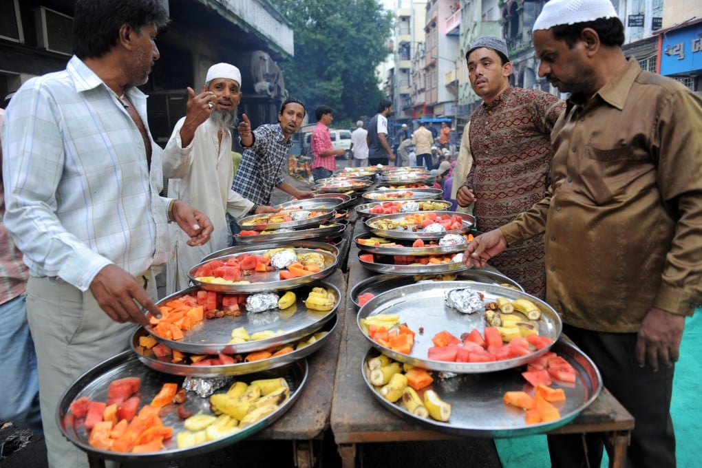 Muslim volunteers in Ahmedabad prepare food for a fast-breaking Iftar party during Ramadan. Photos: AFP