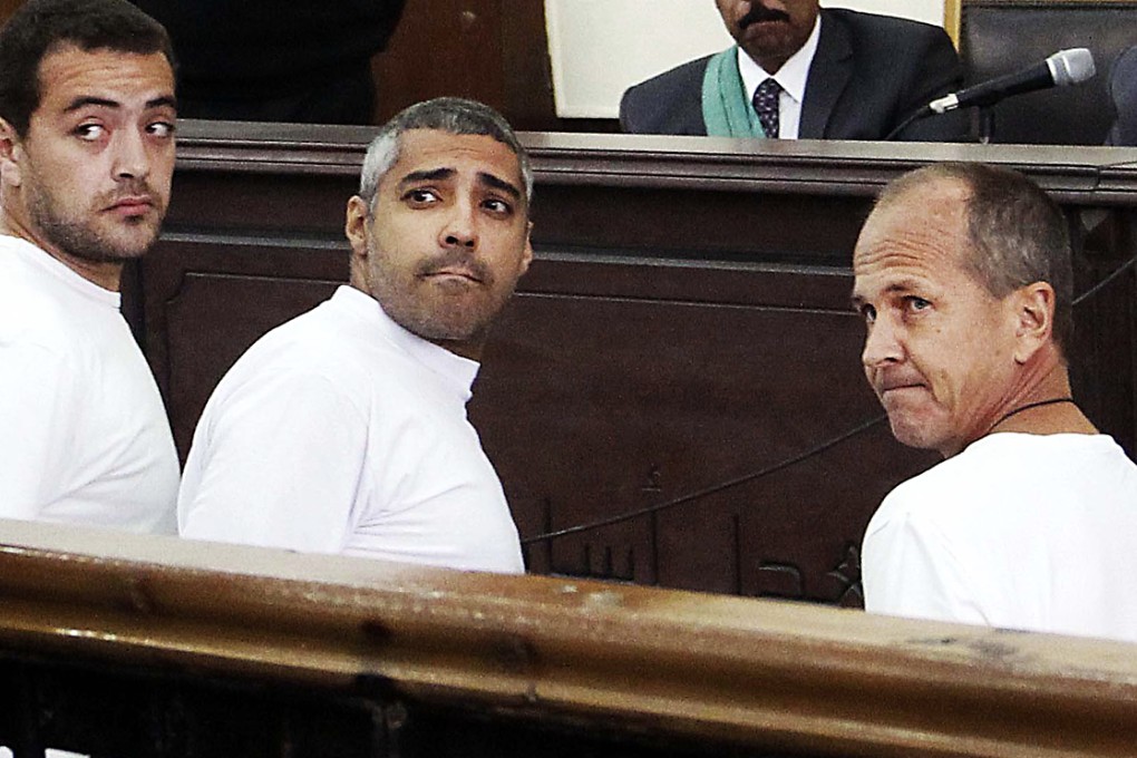 (From left) Al-Jazeera English producer Baher Mohamed, Canadian-Egyptian acting Cairo bureau chief Mohammed Fahmy and correspondent Peter Greste appear in court in Cairo, Egypt. Photo: AFP