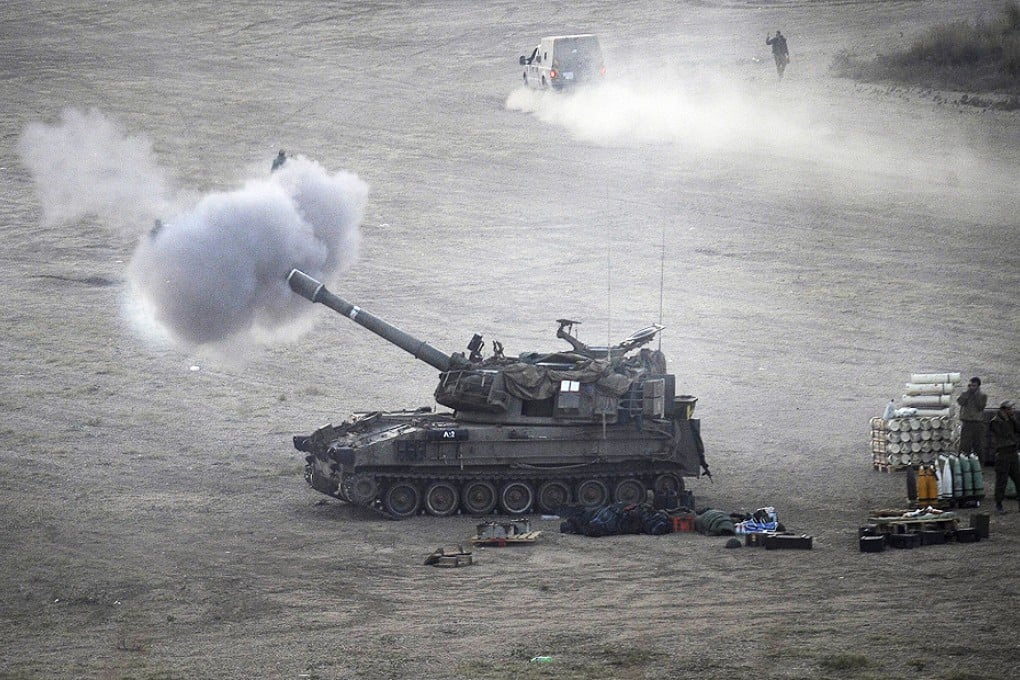 An Israeli tank fires towards targets in the Gaza Strip from its position near Israel's border with the Palestinian enclave. Photo: AFP