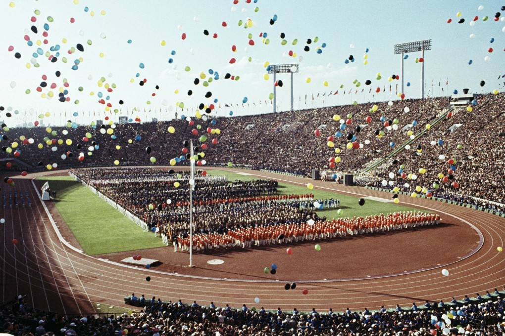 Balloons fly over competitors and spectators during the opening ceremony of the 1964 Summer Olympics at the National Stadium in Tokyo. The event marked Japan's rise from humiliating defeat in the second world war to emerge as a major international player. Photo: AP