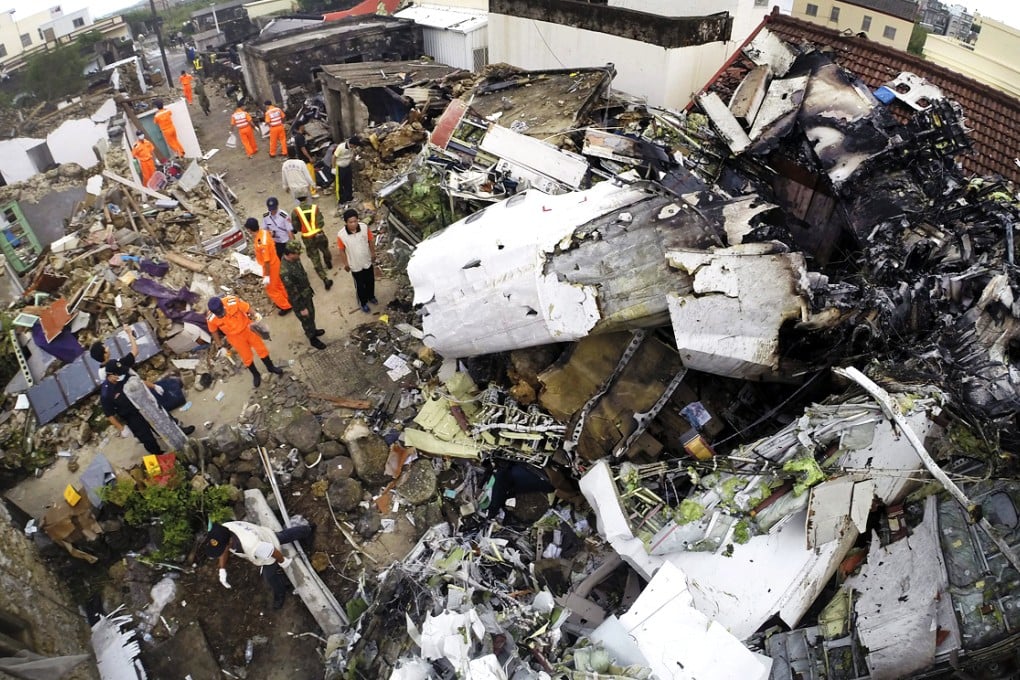 Rescue workers search the wreckage of the ATR-72 plane at the crash site of the TransAasia Airways plane on the Penghu Islands, Taiwan. Photo: EPA