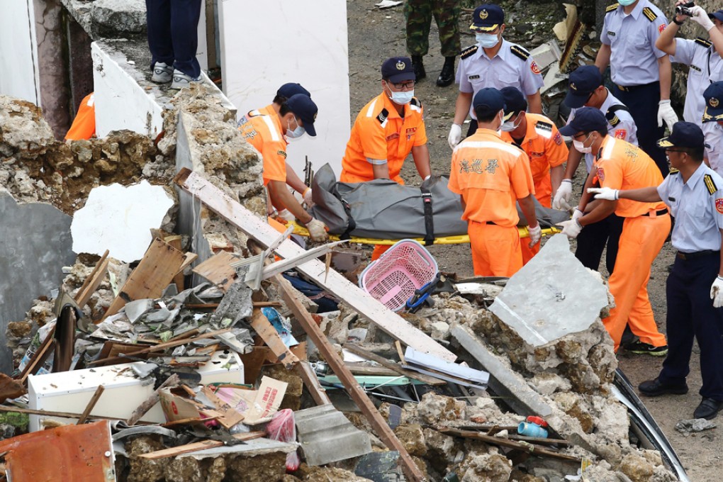 Rescue workers remove a body from the site of the TransAsia Airways plane crash on the Penghu Islands. Photo: EPA