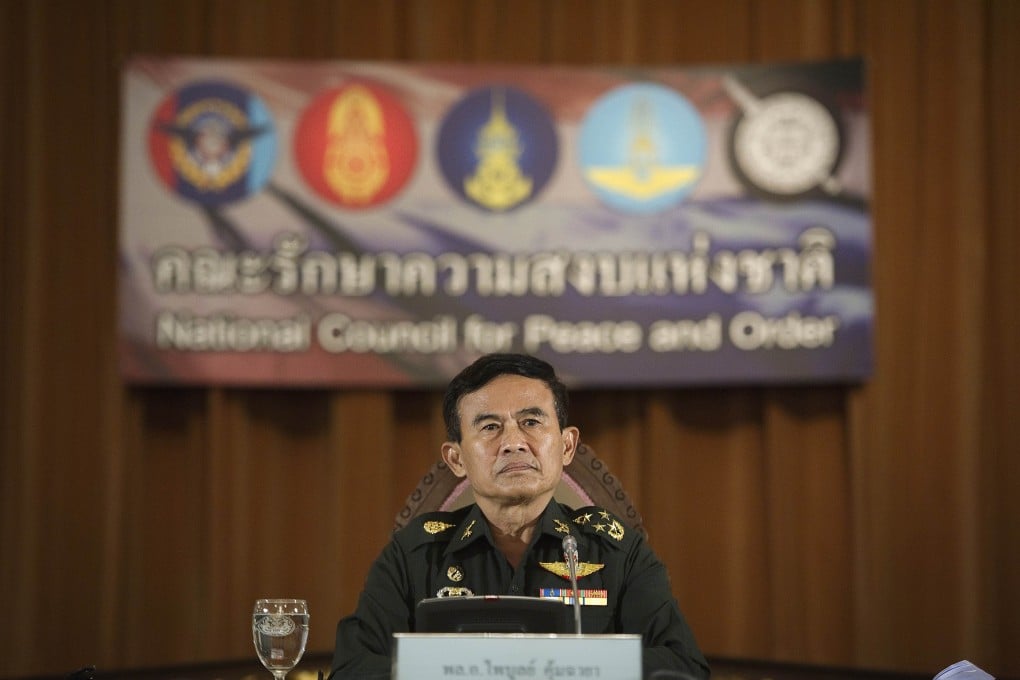 General Paiboon Kumchaya, the junta's chief of legal affairs, announces an interim constitution for Thailand. A military government has ruled Thailand since May. Photo: AFP