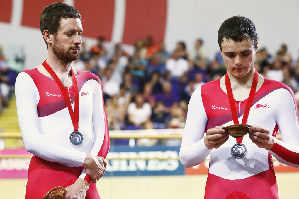 A clearly dissatisfied Bradley Wiggins with England teammate Steven Burke after receiving his silver medal in the men's 4,000m team pursuit at the Commonwealth Games in Glasgow. Photo: Reuters