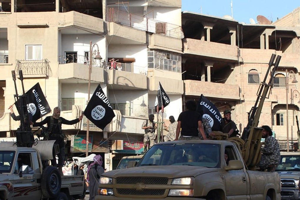 Members of the Islamic State militant group parade in a street in the northern Syrian city of Raqa. Photo: AFP