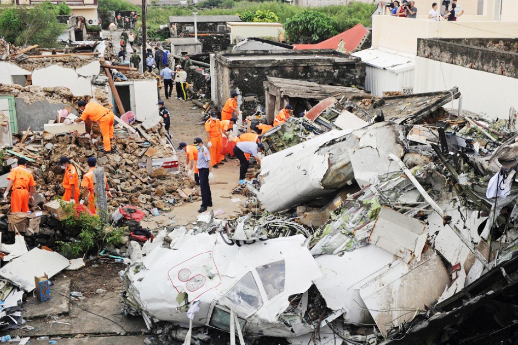 The scene in a village on the Taiwanese island of Penghu after a TransAsia plane crashed while trying to land nearby on Wednesday, killing 48. Authorities are facing criticism for letting the plane fly in poor weather. Photo: AFP
