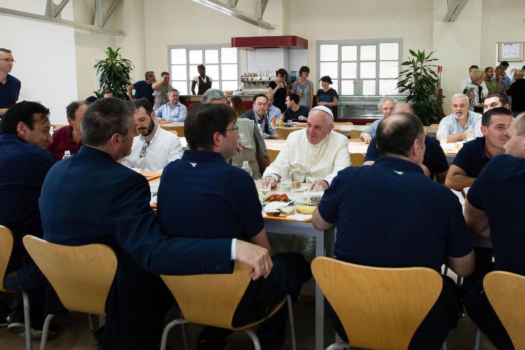 Pope Francis enjoys a meal with Vatican staff. Photo: AFP