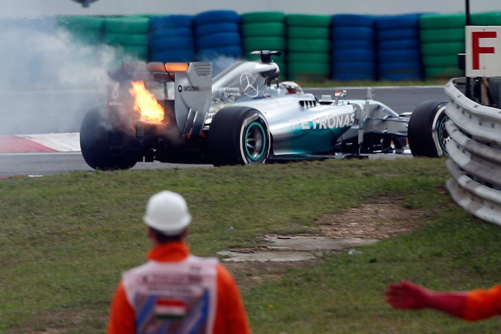 The car of British driver Lewis Hamilton of Mercedes AMG is on fire during the qualifying session at Hungaroring. Photo: EPA
