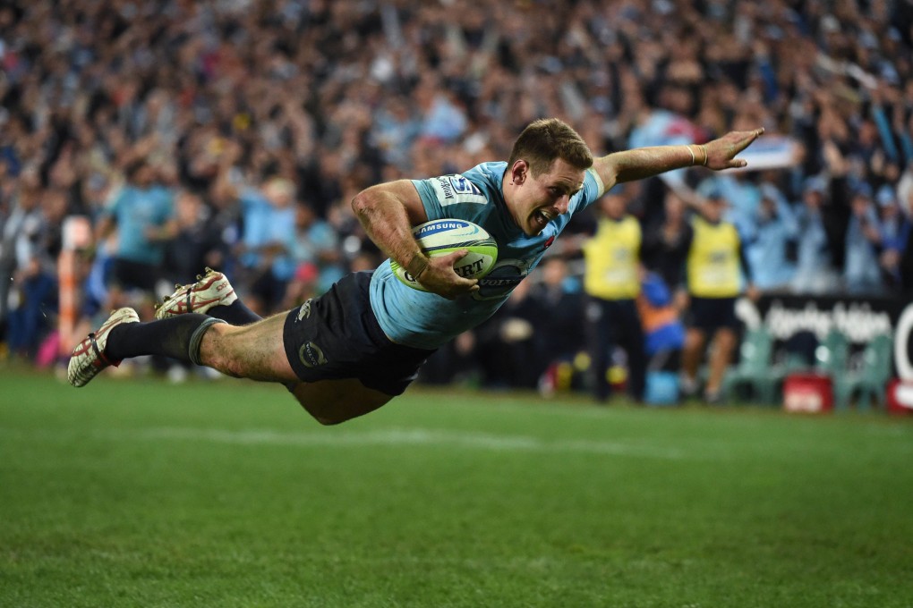 Waratahs fly-half Bernard Foley dives over to score against the Brumbies in their Super 15 semi-final in Sydney. Photo: AFP