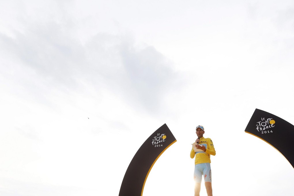 Astana Procycling team rider Vincenzo Nibali of Italy celebrates his overall victory on the podium wearing the leader’s yellow jersey following the 21st and final stage of the Tour de France. Photo: EPA