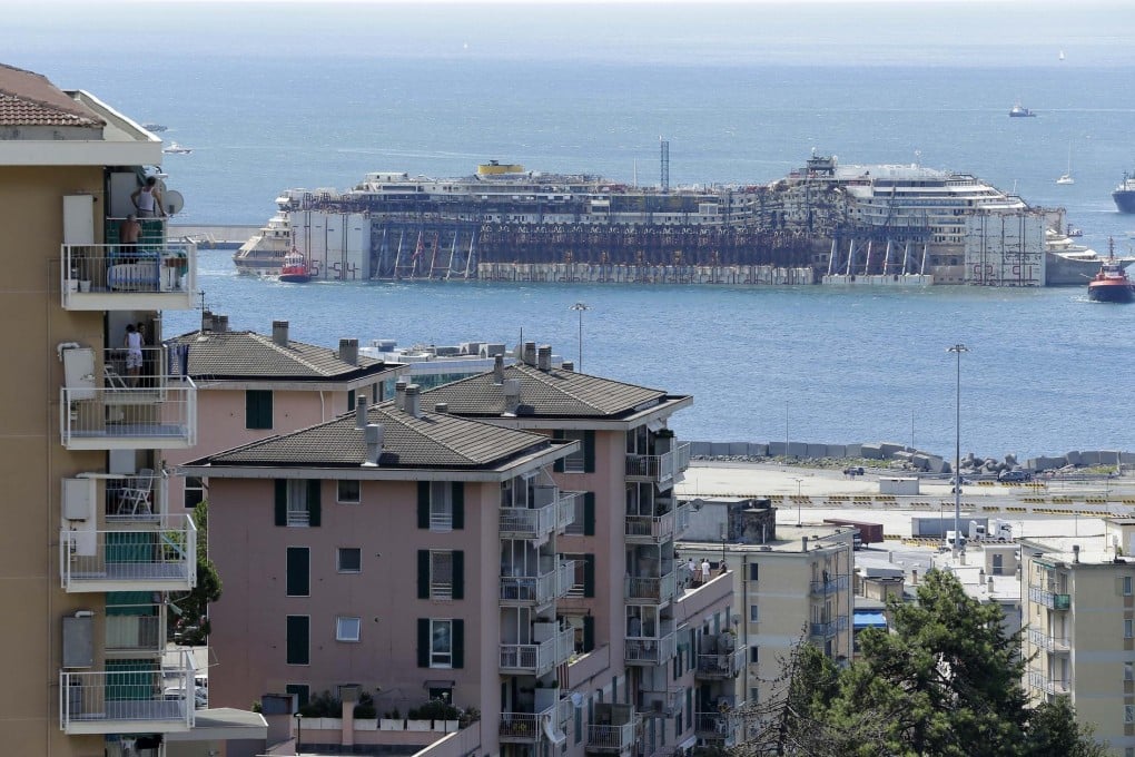 The Costa Concordia is towed to Genoa's harbour yesterday. Italian PM Matteo Renzi thanked salvagers for doing "something that everyone said was not possible". Photo: AP