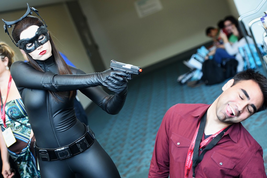Attendee Genevieve Nylen dressed as Cat Woman play acts with a toy gun at the 45th annual Comic-Con in San Diego, California. Photo: AFP