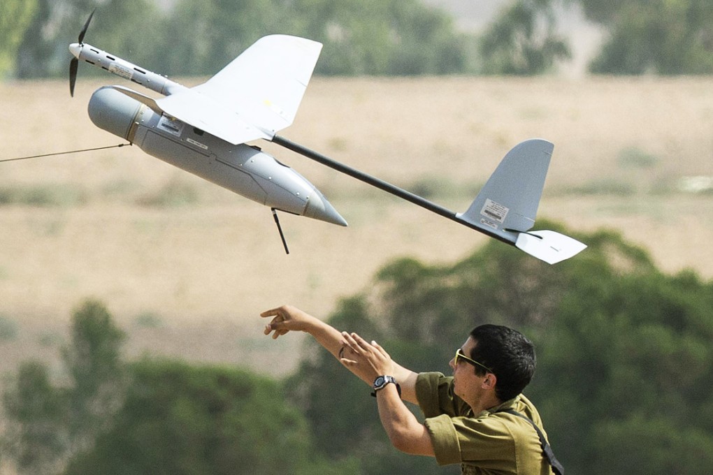 An Israel soldier launches an Israeli army's unmanned drone aircraft, which is used for monitoring purposes. Photo: AFP