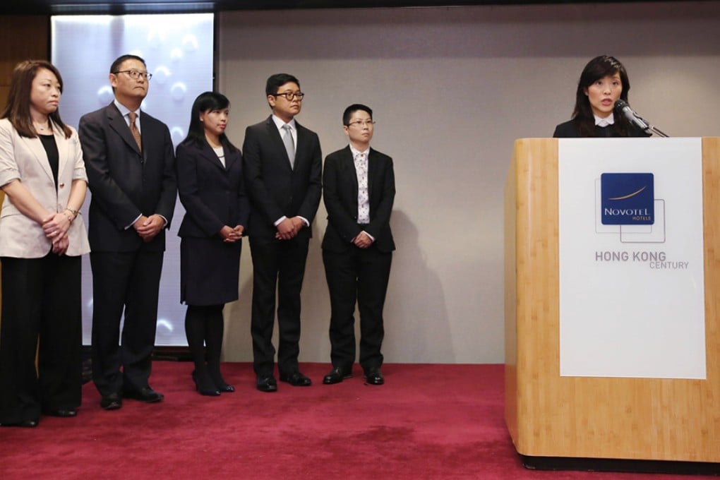 McDonald's Managing Director Randy Lai Wai-sze (right) attends a press conference on "rotten meat" scandal.