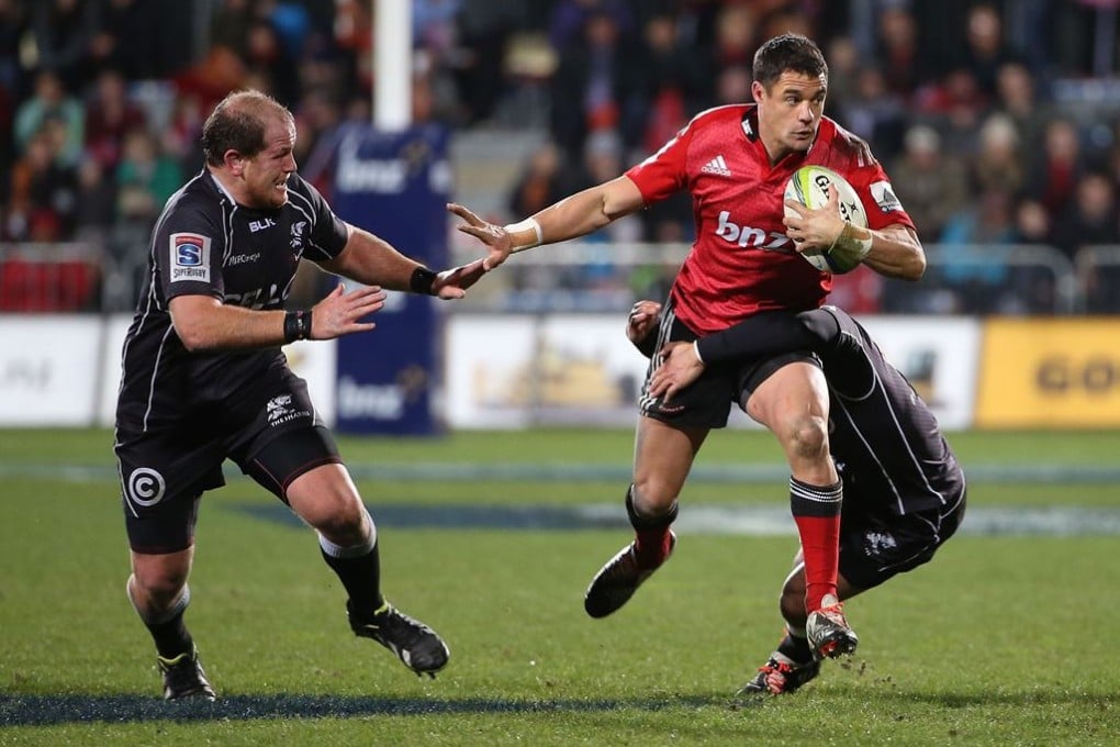 Dan Carter, shown here carrying the charge for the Canterbury Crusaders against the Coastal Sharks during their Super Rugby semi-final on Saturday, is back in the All Blacks squad for the upcoming Rugby Championship. Photo: AFP