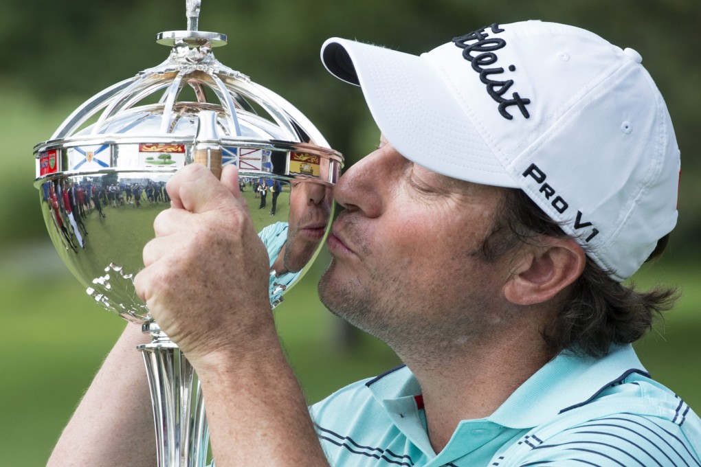 South Africa's Tim Clark kisses the winning trophy after winning the Canadian Open. Photo: AP