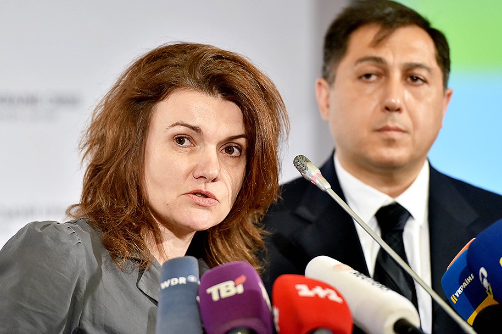 Fiona Frazer, Deputy Head of the UN)Human Rights Monitoring Mission in Ukraine, speaks, flanked by mission head Armen Harutyunyan, during a press conference in the Ukraine Crisis Media Centre in Kiev. Photo: AFP