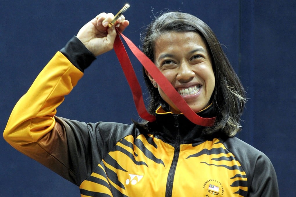 Malaysia's Nicol David shows off her gold medal on the podium after winning the singles squash title at the Commonwealth Games. Photo: AFP