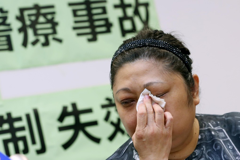 Jenny Yuen wipes away tears yesterday as she talks about her father's death. The family is considering suing the hospital. Photo: Nora Tam