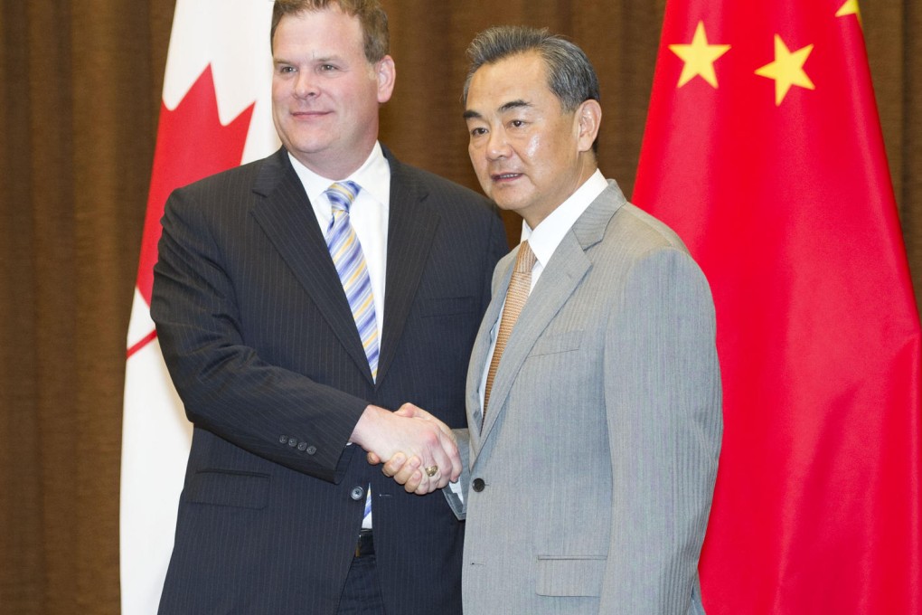 Foreign ministers John Baird and Wang Yi. Photo: Xinhua