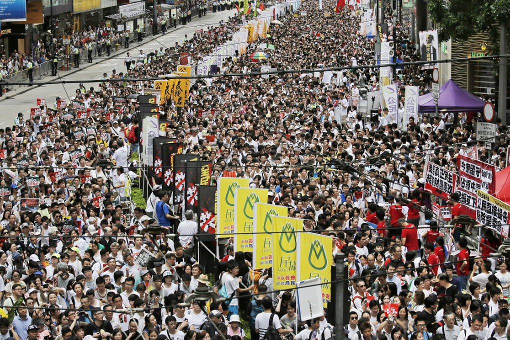 Pro-democracy protesters march on July 1 in Hong Kong. Photo: AP