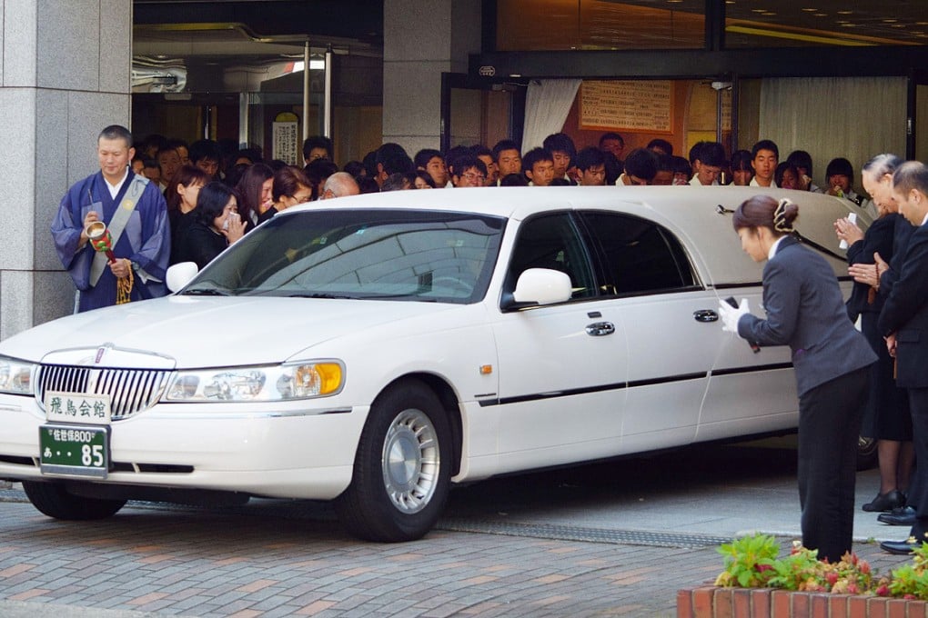 A hearse carrying the coffin of Japanese schoolgirl Aiwa Matsuo leaves the funeral hall in Sasebo, western Japan. Photo: AFP