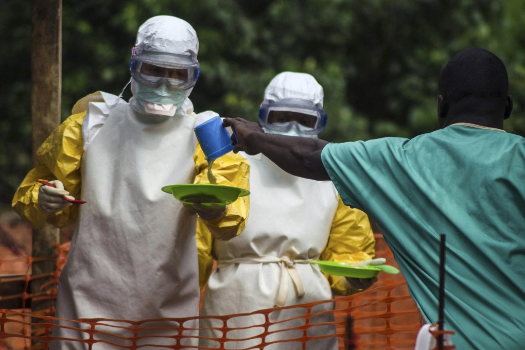 Medecins sans Frontieres staff face great pressures. These staff prepare food for patients kept in an isolation area at an Ebola treatment centre in Sierra Leone. Photo: Reuters