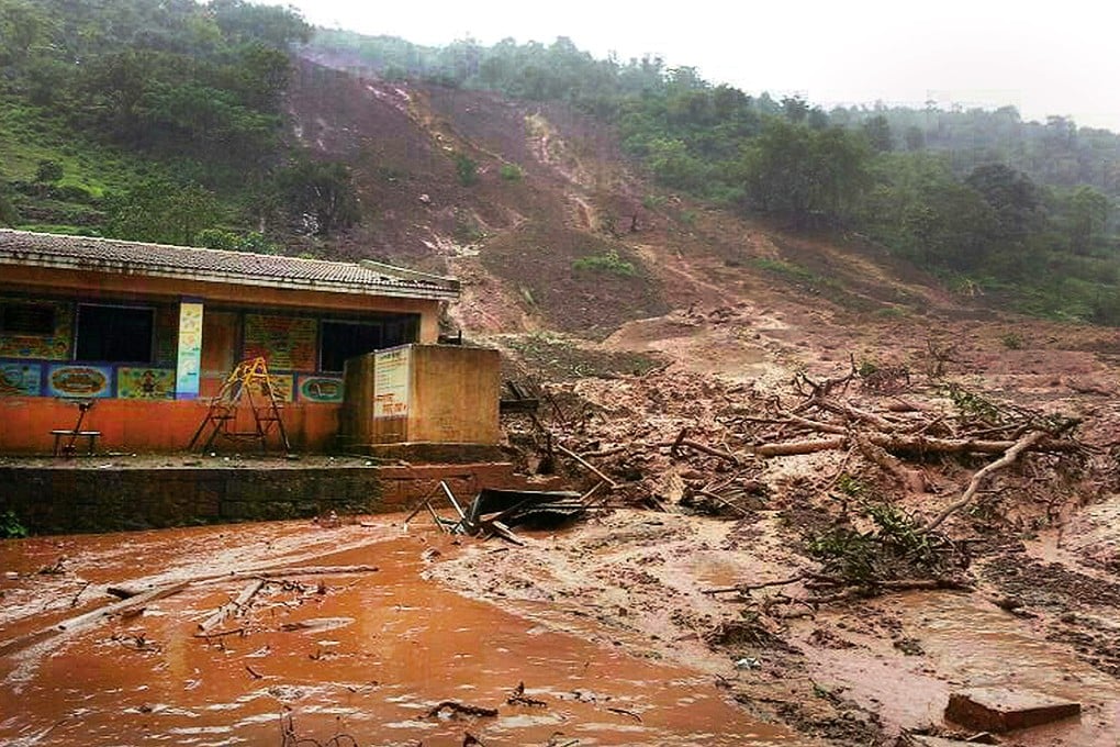 A landslide surrounds a building in Malin village in Pune district, in the western Indian state of Maharashtra. Photo: AFP