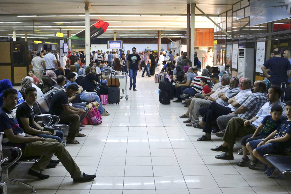 Passengers wait for flights in a hall at Tripoli's Mitiga airport, after clashes between rival militias closed Tripoli International Airport. Photo: Reuters