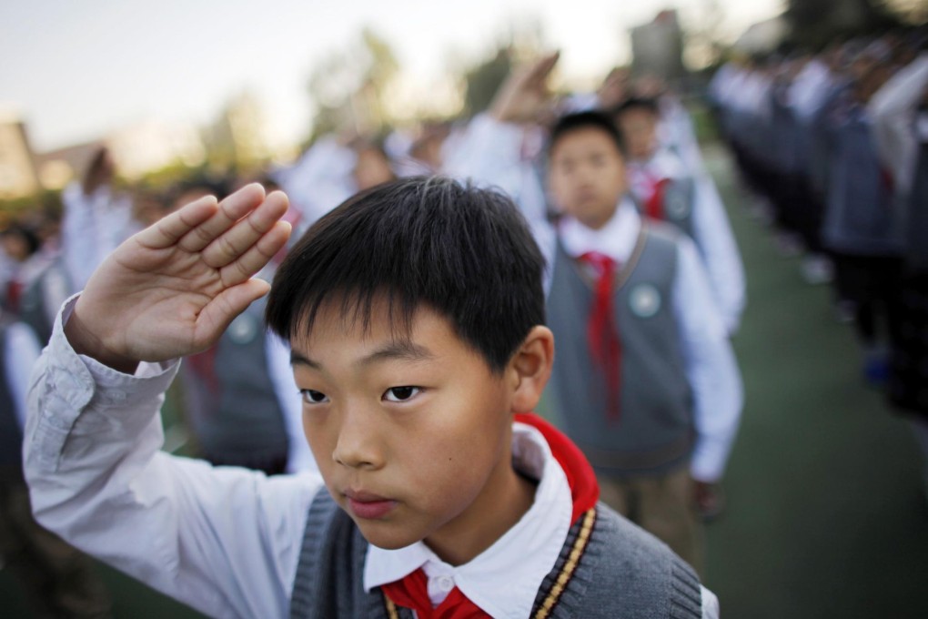 A pupil salutes the flag at a Shanghai school. Photo: Reuters