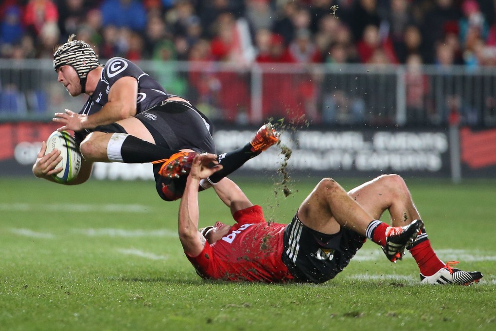 Kieron Fonotia (right) of the Crusaders tackles Stephan Lewies of the Coastal Sharks during their Super 15 semi-final. Photo: AFP
