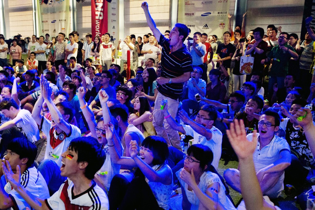Chinese soccer fans celebrate after Germany won the World Cup. Photo: AP