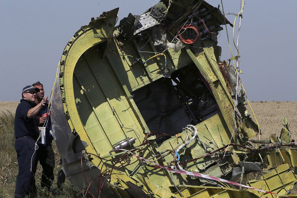 International experts inspect wreckage at the crash site of the downed Malaysia Airlines flight MH17 near Grabove in the Donetsk region of eastern Ukraine. Photo: Reuters