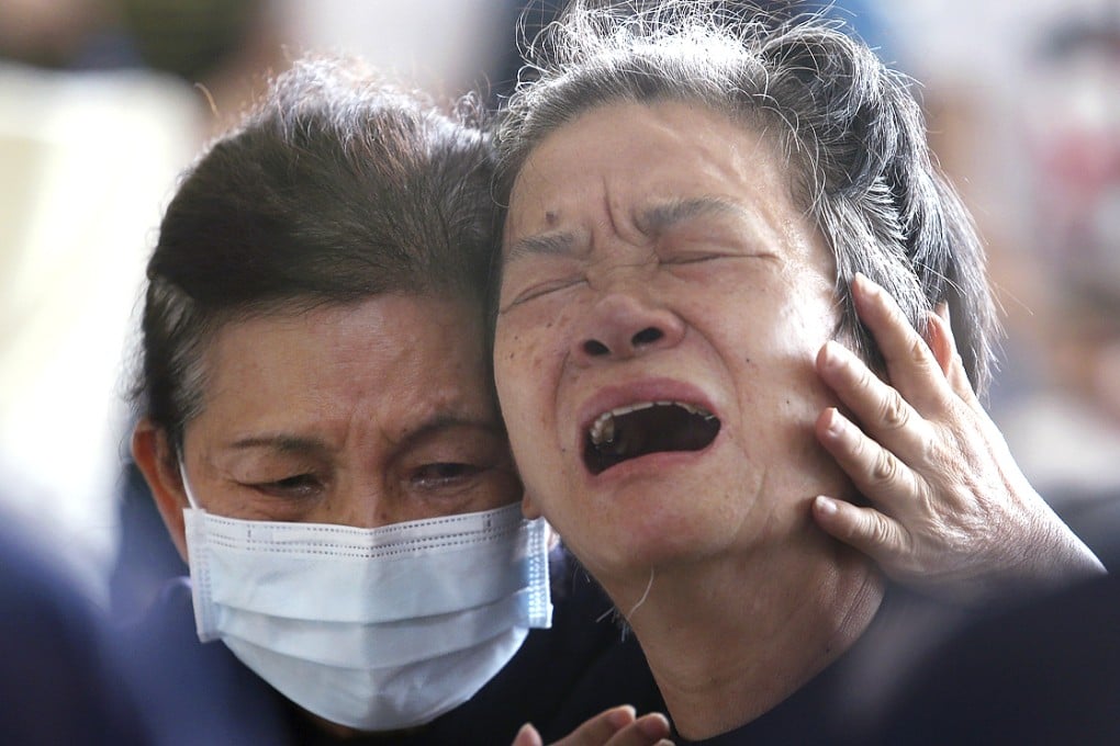 Relatives grieve as the rescue operation continues. Photo: Reuters