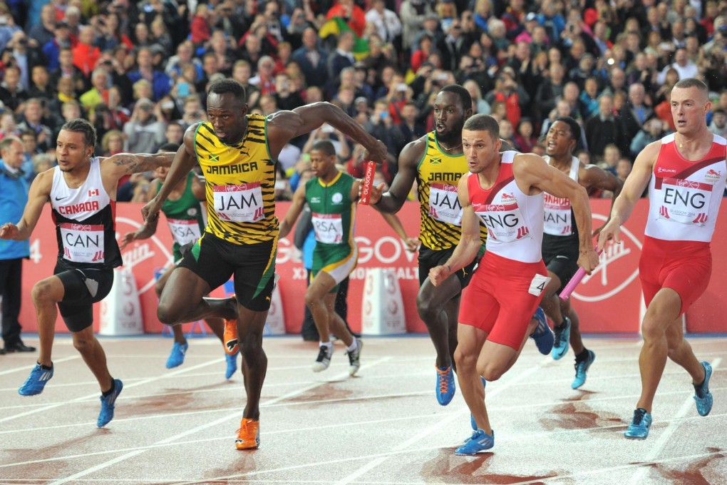 Jamaica's Usain Bolt takes the baton for the anchor leg of the 4x400m relay. Photo: AFP