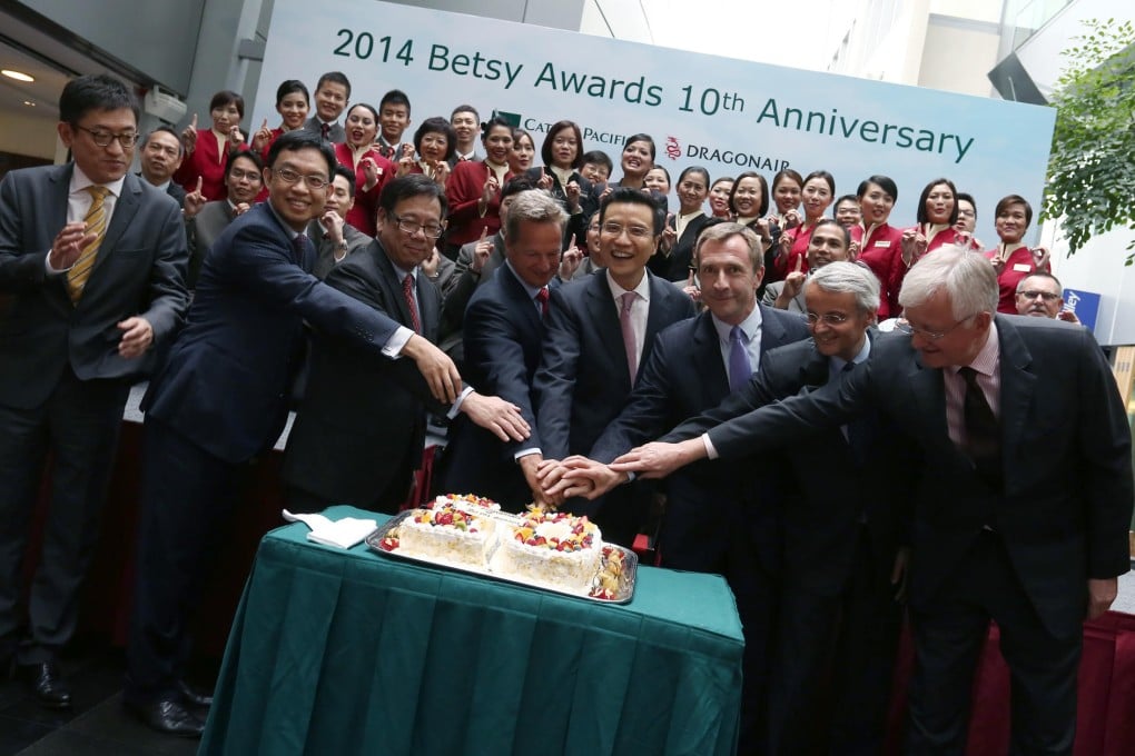 Cathay Pacific and Dragonair executives show their hands-on appreciation in front of award winners yesterday. Photo: Jonathan Wong